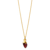 A raw crystal garnet pendant attached to a gold-filled chain against a white background