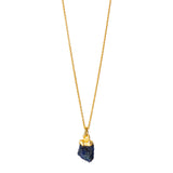 A raw Sapphire pendant electroplated in gold, hanging from a gold cable chain.