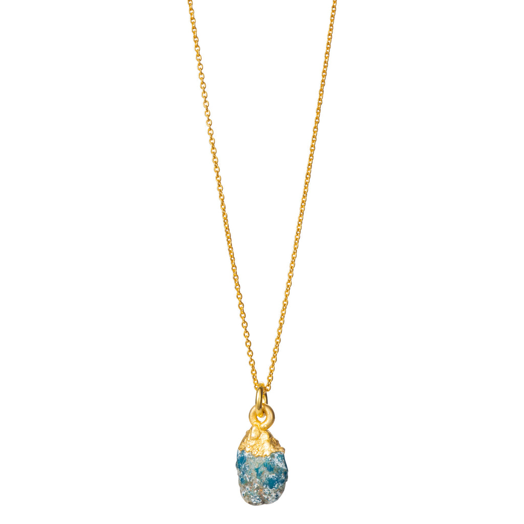 A raw Turquoise crystal pendant electroplated in gold, hanging from a gold-filled cable chain necklace.